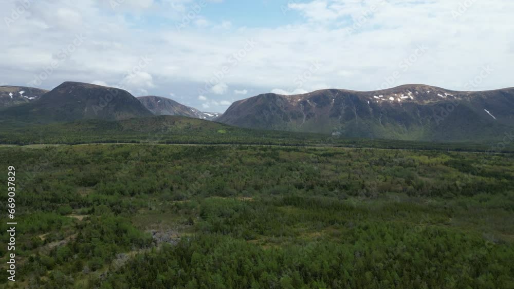Aerial shot showcases the breathtaking beauty of a mountainous terrain, located in Newfoundland Aerial shot showcases the breathtaking beauty of a mountainous terrain, located in Newfoundland
