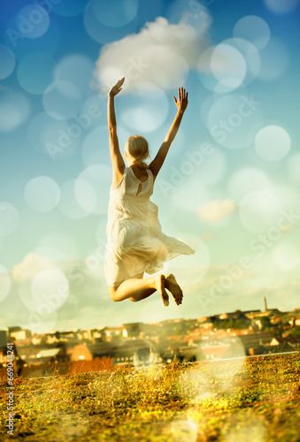 Woman, jumping and freedom with back, vacation, and outdoor for holiday, bokeh and city. Confident, energy and urban area for break, getaway and carefree with sky, barefoot and amsterdam spring time photo