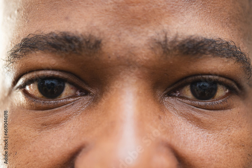 Eyes of african american potter looking on camera in pottery studio photo
