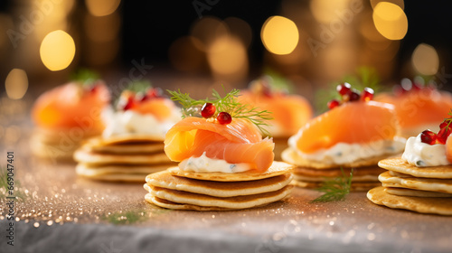 Luxurious smoked salmon blinis with a dot of creme fraiche, Christmas party, blurred background, with copy space photo
