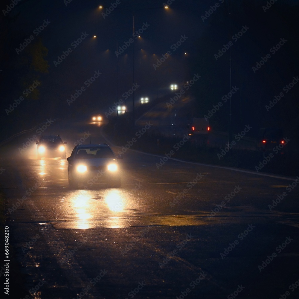 Cars on the road in the fog. Autumn and winter concept of dangerous traffic in bad weather. Car lights in bad visibility. Cars on the road in the fog. Autumn and winter concept of dangerous traffic in bad weather. Car lights in bad visibility.