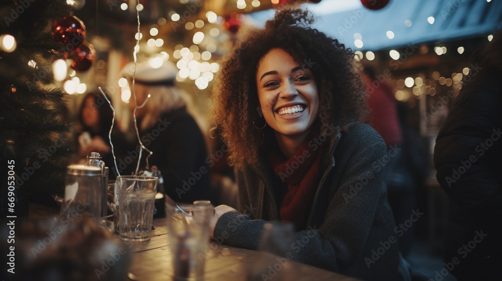 Young afro man smiles and has a drink at Christmas on a street busy with people Young afro man smiles and has a drink at Christmas on a street busy with people