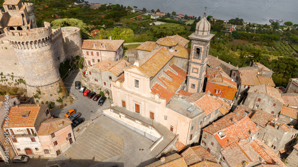 Aerial view of the collegiate church of Santo Stefano Protomartire. It is the cathedral of the town of Bracciano, in the metropolitan city of Rome, Italy. It overlooks Lake Bracciano.