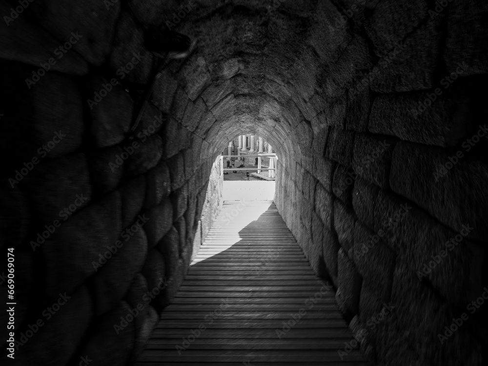 Black and white photo of an entrance to the Roman Amphitheater of Merida.