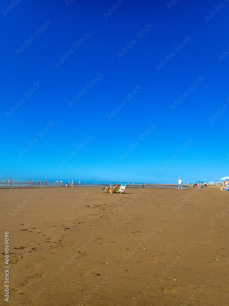 People enjoying a sunny summer day at Isla Canela Beach, in Ayamonte, Spain.