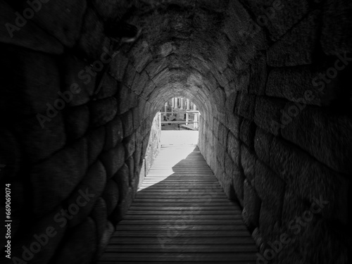 Black and white photo of an entrance to the Roman Amphitheater of Merida.