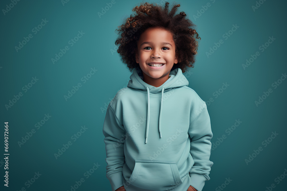 adorable little Afro American boy poses on blue studio background adorable little Afro American boy poses on blue studio background
