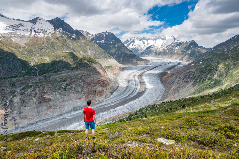 Man looking at the Aletsch glacier in Switzerland