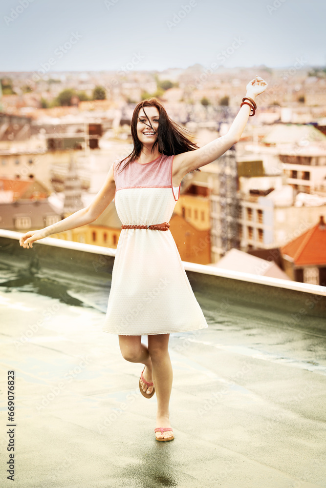 Woman, arms and happy on rooftop for travel, adventure and freedom on trip to Croatia, cityscape and sky. Female person, vacation and happy or positive for getaway, energy and stretching in holiday