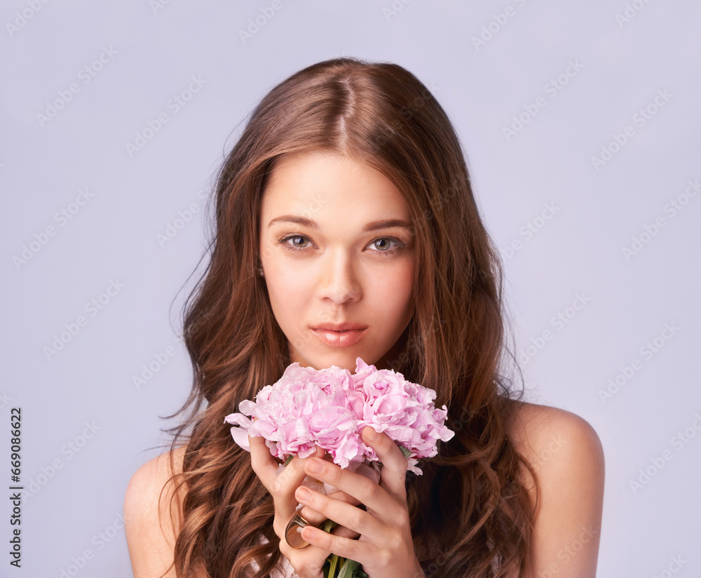 Woman, portrait and bouquet for beauty in studio, wellness and skincare for care, makeup and cosmetic. Female model person, flowers and face for luxury, organic and aesthetic by purple background