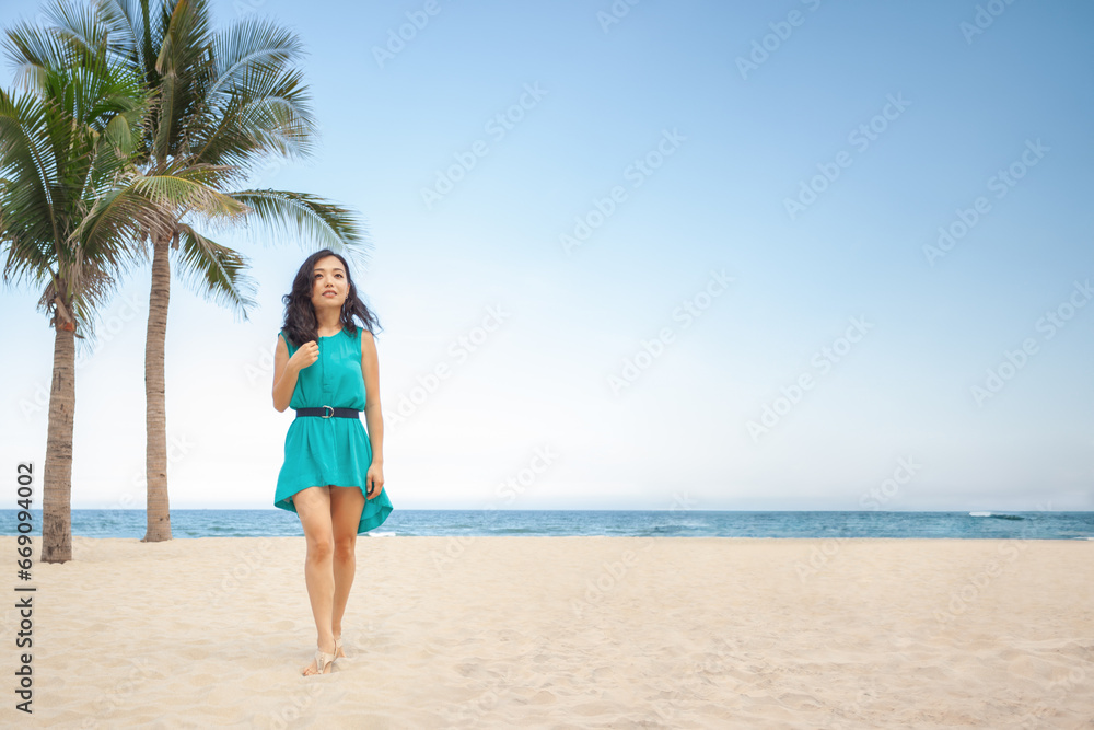 Happy traveler Asian woman in dress relax on the tropical beach. Summer, travel and holiday concept.