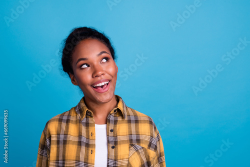 Photo of adorable positive lady look empty space hands cheeks wear white shirt isolated blue color background