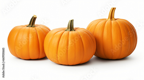 An arrangement of three pumpkins isolated on white wall