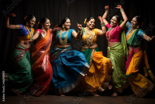 Cheerful Indian women in national costumes dancing