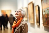 Elegant senior woman appreciating art in a gallery.