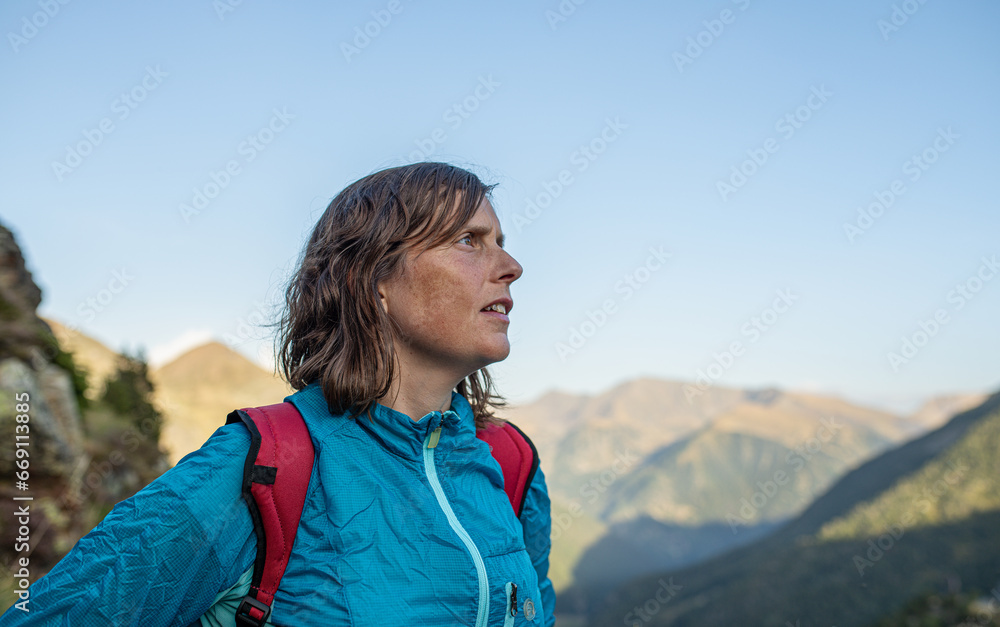 young caucasian girl looking at the horizon from the mountains of andorra