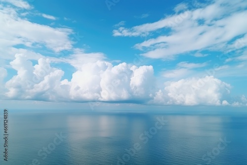 Ocean with huge white clouds © Oksana