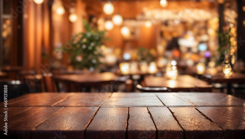 A wooden table in a restaurant or bar. The table is in the foreground and the background is blurred. The atmosphere is warm and welcoming.