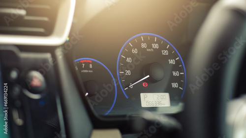 Car speedometer dashboard illuminated in the dark. Engine speed and rpm gauge. Automotive display.
