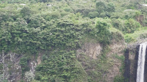rainforest at the spectacular waterfall of El Pailon del Diablo close to Banos Santa Agua in the andes mountains of Ecuador, South America.