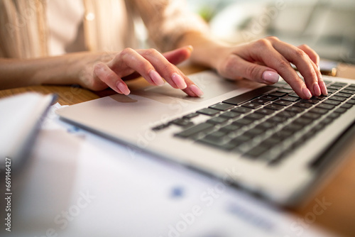 Close up of female hands typing on laptop