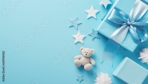 Baby accessories concept top view photo of gift box teether knitted bunny rattle toy and stars on isolated pastel blue background with empty space