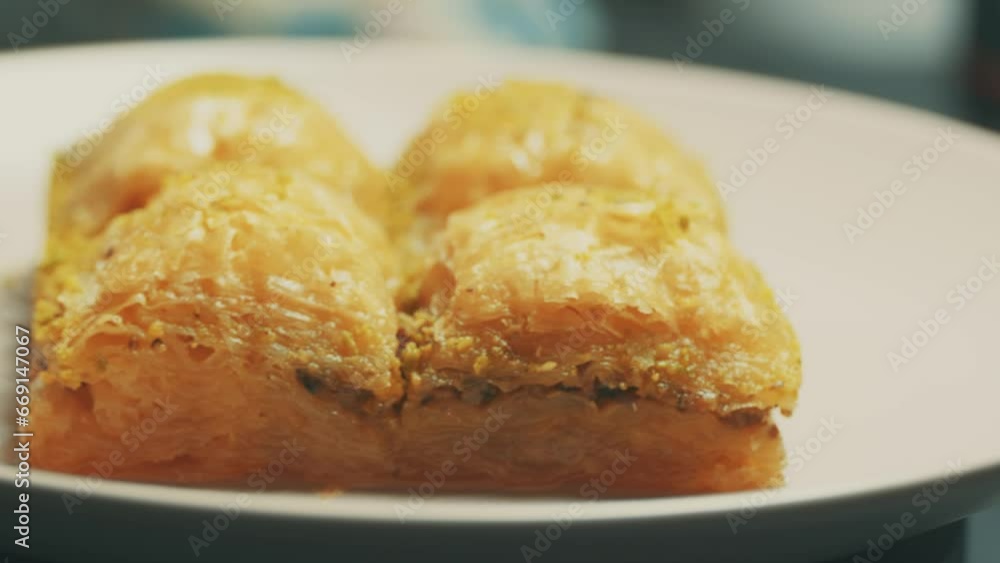 Local Turkish baklava on a white plate in a 360 degree rotating display case
Local Turkish baklava on a white plate in a 360 degree rotating display case