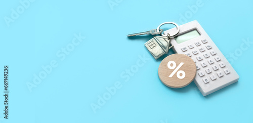 Concept of housing loan percentage and interest rate.Calculator with house model and percentage symbol.