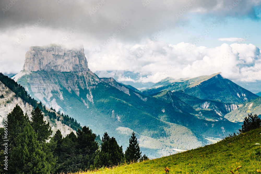 Fototapeta premium View of Mont Aiguille in the Vercors from the Alpine Meadows and Cliffs of the Vallon De Combeau Nature Reserve near Chatillon en Diois in the South of France