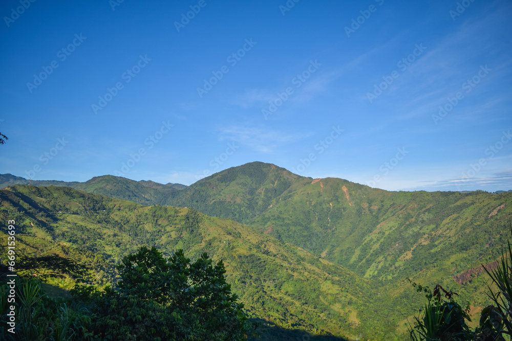 Green mountains with a blue sky