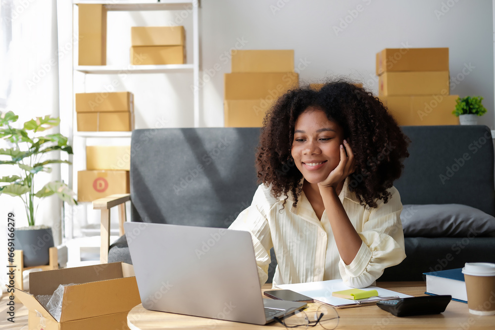 African American businesswoman sitting at the desk in front of the laptop and thinking. African American businesswoman sitting at the desk in front of the laptop and thinking.