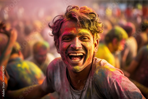Vibrant Holi festivity: an individual adorned in vivid Indian paint, celebrating with others, embracing the colorful essence of the event © Konstiantyn Zapylaie