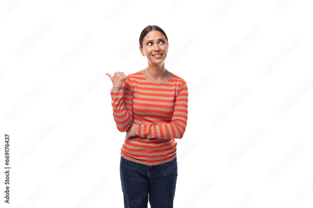 a young caucasian woman with black hair dressed in a striped orange jacket gesticulates with her hands, attracting attention a young caucasian woman with black hair dressed in a striped orange jacket gesticulates with her hands, attracting attention