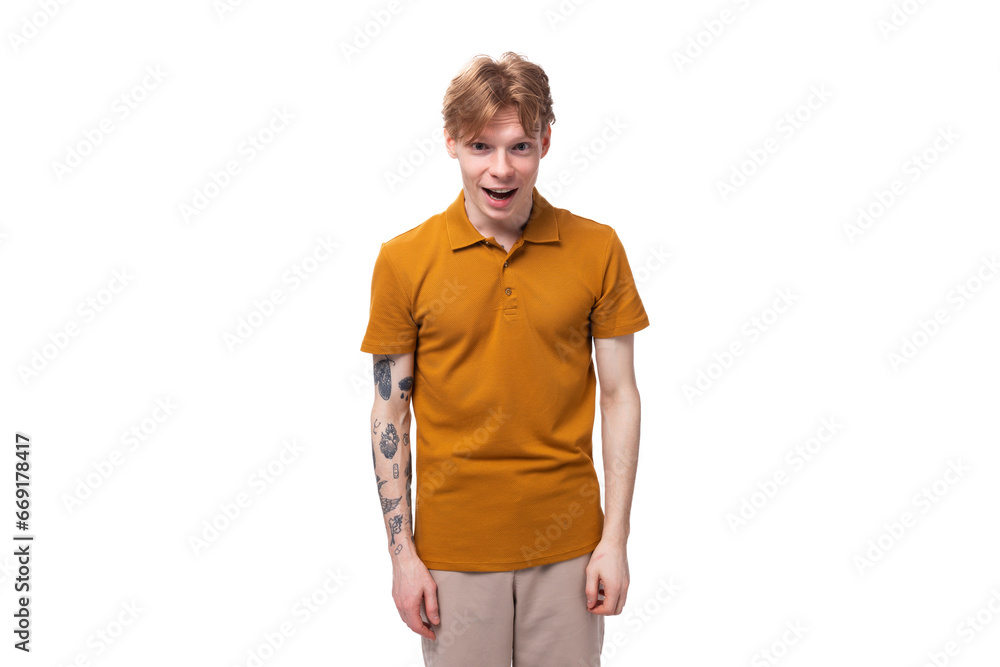 surprised red-haired guy dressed in an orange t-shirt on a white background surprised red-haired guy dressed in an orange t-shirt on a white background