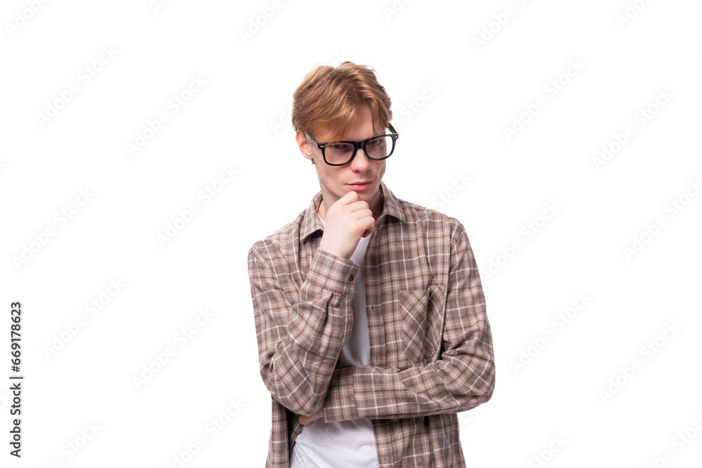 close-up portrait of a young dreaming caucasian man with red short hair in glasses and a shirt on a white background close-up portrait of a young dreaming caucasian man with red short hair in glasses and a shirt on a white background