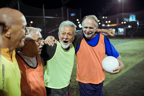 Elderly friends share a joyful moment after a football match photo