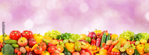 Multicolored bright fruits and vegetables on lilac background.