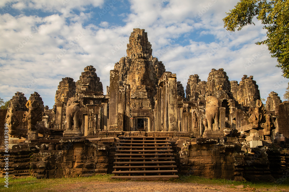 Main entrance and view of Bayon temple with its half-collapsed columns, near Angkor Cambodia, at sunset.