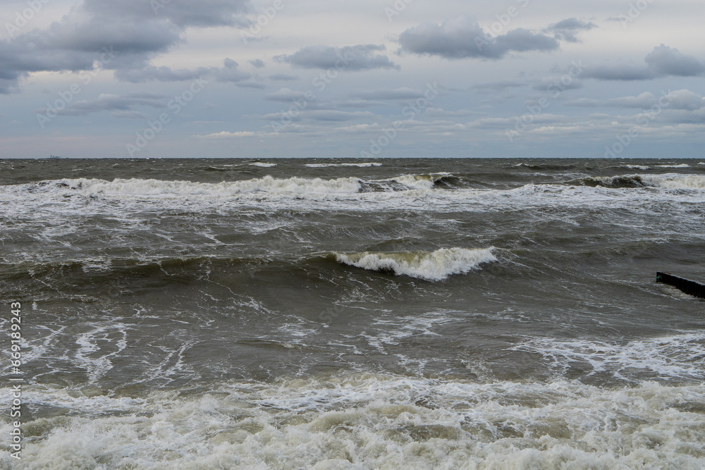 seashore on a cloudy cloudy day, strong storm waves