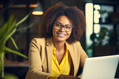 The portrait of a female business woman with an Afro hairstyle working on a laptop in the co-working space of the office. Generative AI.