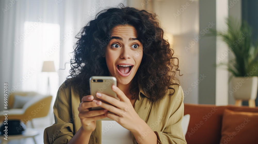 Female Brazilian model cheers in surprise with a phone in her hand Female Brazilian model cheers in surprise with a phone in her hand