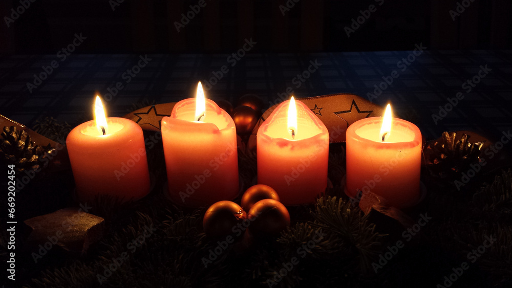 Four burning candles in the dark at Christmas season Four burning candles in the dark at Christmas season