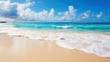 Beautiful natural tropical summer beach background with golden sand, turquoise ocean, and blue sky with white clouds