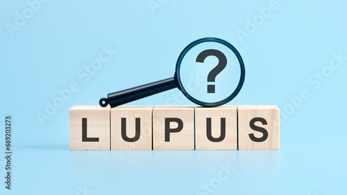 lupus word written on wood block. lupus text on table, concept. photo