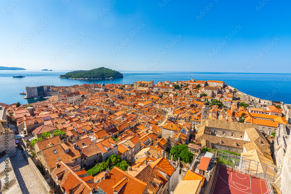 Aerial view of the red tiles and building roofs old city Dubrovnik in a beautiful summer day, Croatia. Blue sea with beautiful landscape, aerial view, Dubrovnik, Croatia