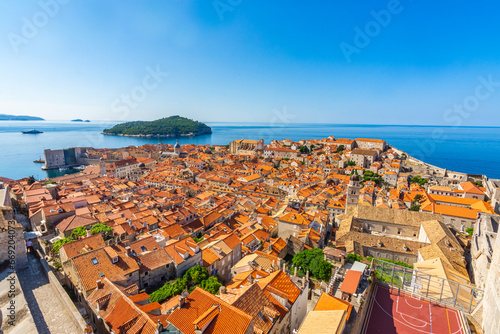 Fototapeta Naklejka Na Ścianę i Meble -  Aerial view of the red tiles and building roofs old city Dubrovnik in a beautiful summer day, Croatia. Blue sea with beautiful landscape, aerial view, Dubrovnik, Croatia