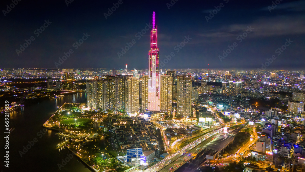 Aerial sunset view at Landmark 81 - it is a super tall skyscraper and Saigon bridge with development buildings along Saigon river, cityscape in the night - obrazy, fototapety, plakaty 