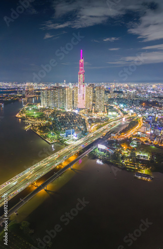 Aerial sunset view at Landmark 81 - it is a super tall skyscraper and Saigon bridge with development buildings along Saigon river, cityscape in the night