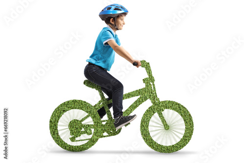 Boy with a helmet riding a green eco bicycle
