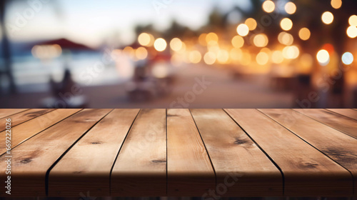 empty wooden table with blurry beach bar background photo